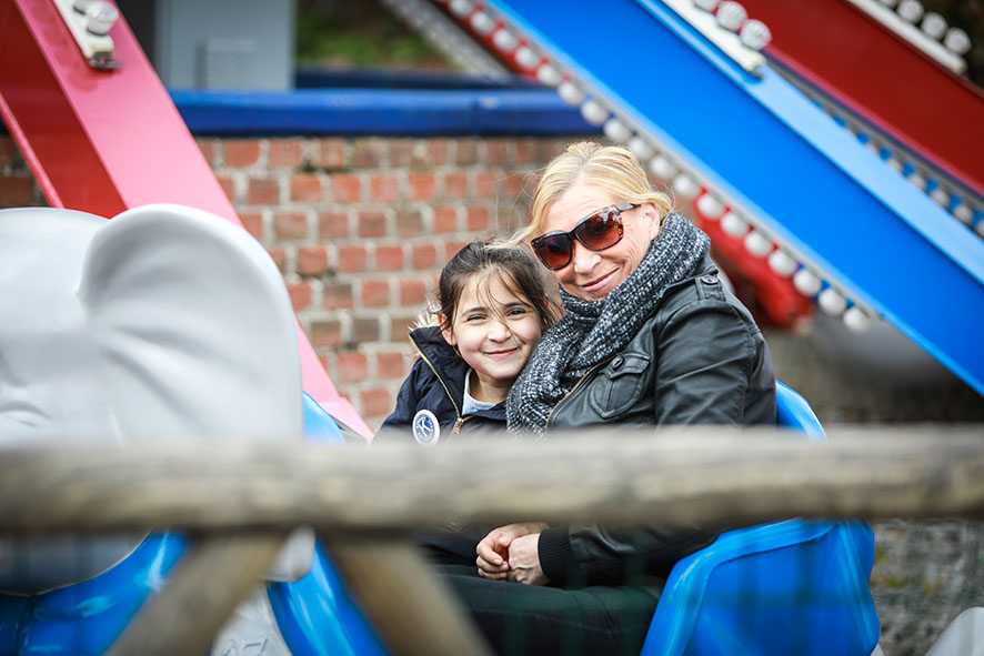 little girl with mother fairground