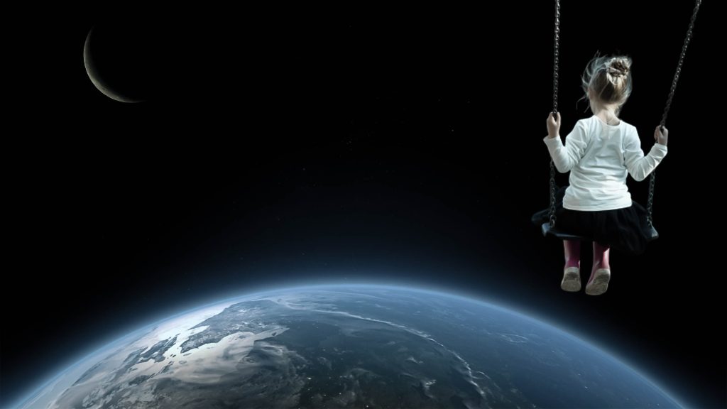 girl on a swing above the earth