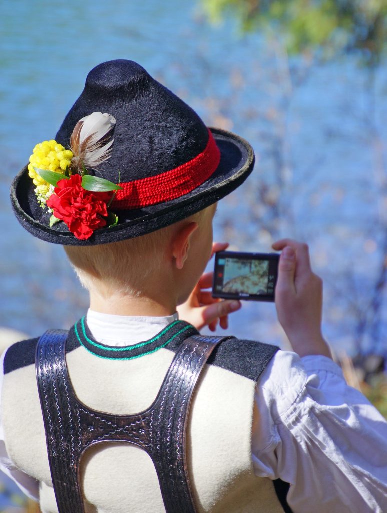 folklore dressed boy smartphone